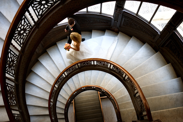 wedding photo by Bob and Dawn Davis Photography, bride and groom, beautiful circular stairwell 